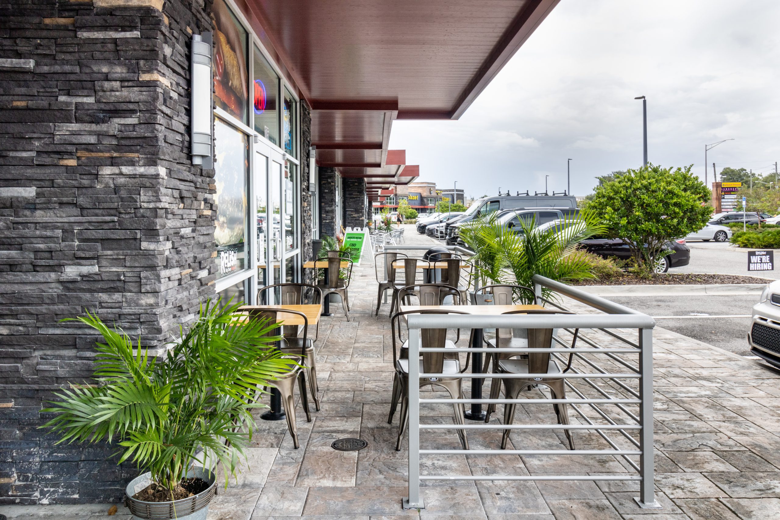 The exterior of a restaurant including an outdoor seating area.