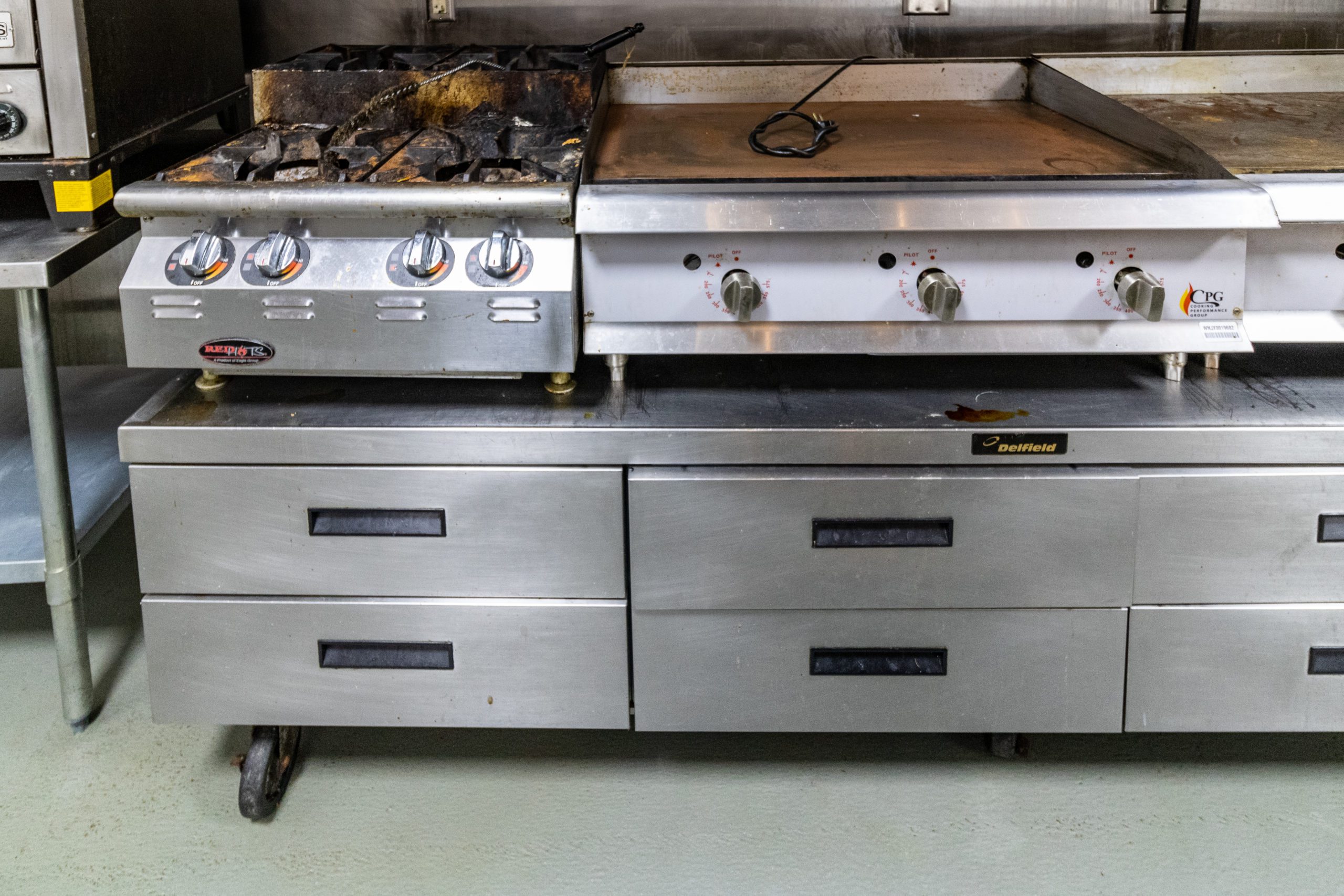 A commercial fryer & stovetop.