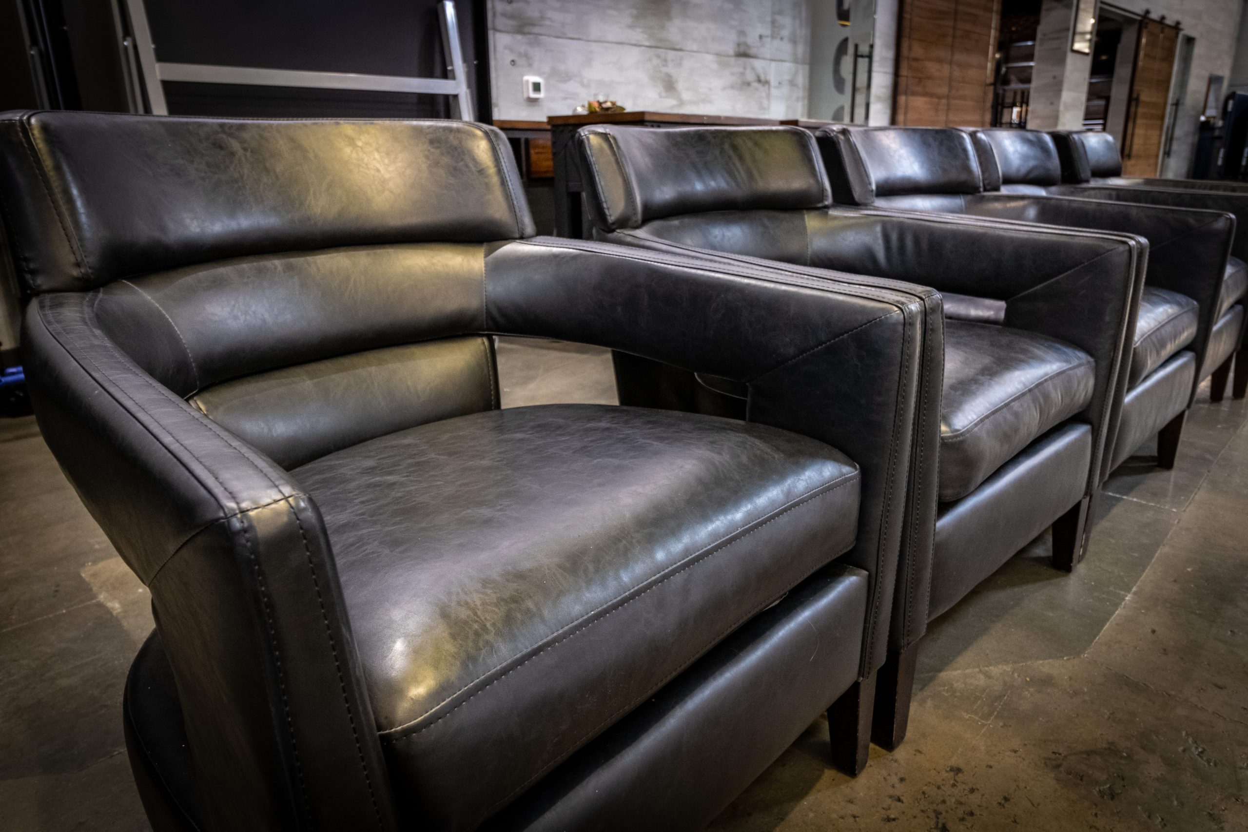 A row of black leather chairs.